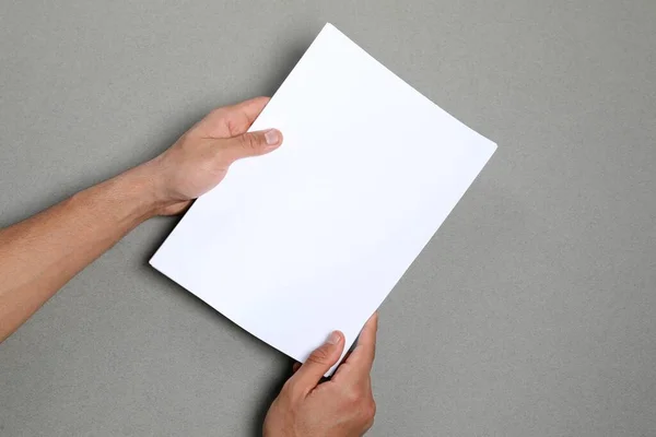 Man Holding Sheets Paper Grey Background Closeup Mockup Design — Stock Photo, Image