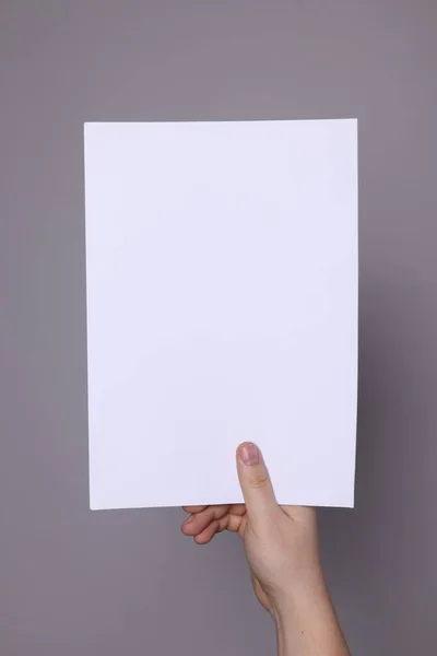 Woman Holding Sheet Paper Grey Background Closeup Mockup Design — ストック写真