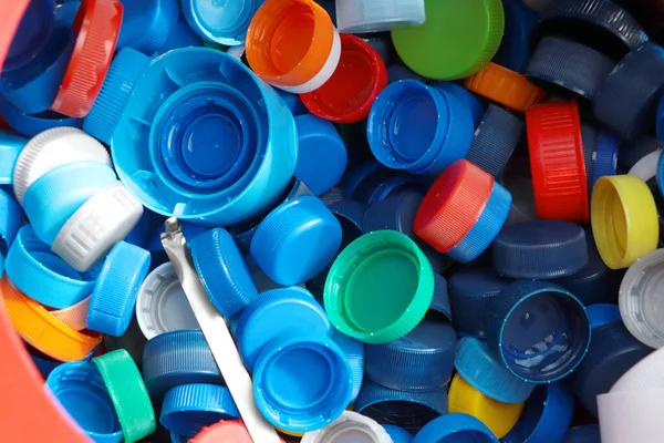 Different colorful bottle caps, top view. Plastic recycling