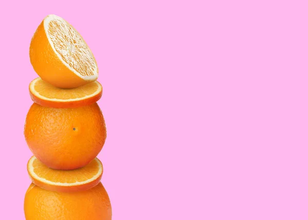 Stacked Cut Whole Oranges Pink Yellow Background Space Text — Stock Photo, Image