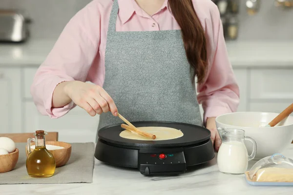 Woman Cooking Delicious Crepe Electric Maker White Marble Table Kitchen — Stok fotoğraf