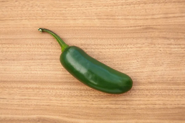 stock image Fresh green jalapeno pepper on wooden table, top view