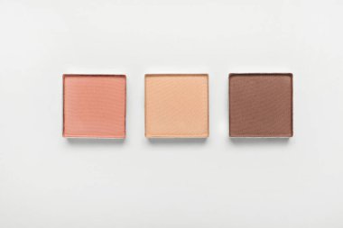 Different beautiful eye shadows on white background, flat lay