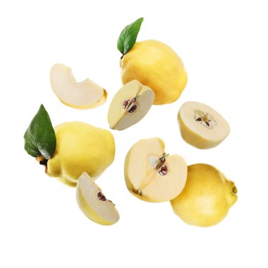 Fresh quinces with green leaves falling on white background