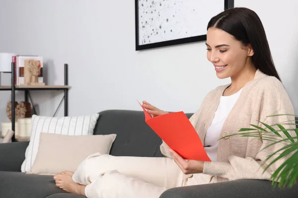 Happy Woman Reading Greeting Card Sofa Living Room — Stok fotoğraf