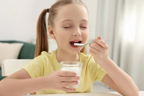 Cute Little Girl Enjoying Tasty Yogurt White Table Home — Stock Photo, Image
