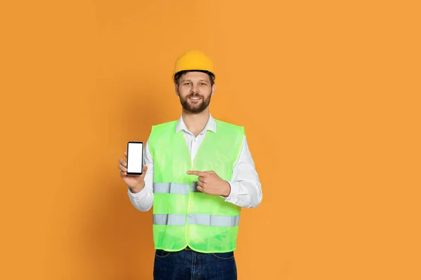 Man Reflective Uniform Showing Smartphone Orange Background — Stock Photo, Image
