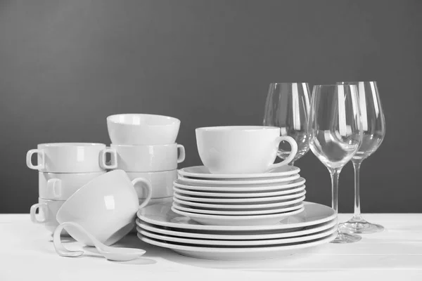 Set Clean Dishware Glasses White Wooden Table Grey Background — Stok fotoğraf