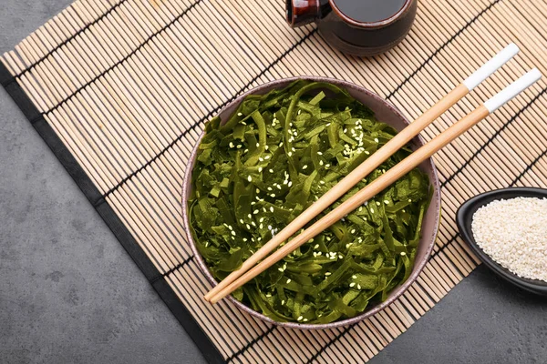 stock image Fresh laminaria (kelp) seaweed served on black table, flat lay