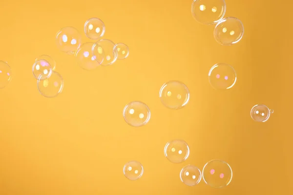 Many Beautiful Soap Bubbles Orange Background — Stockfoto
