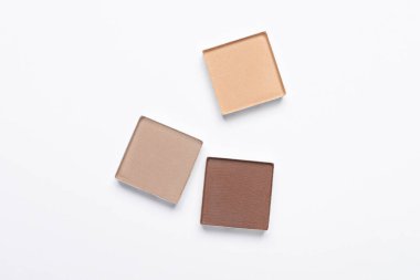 Beautiful eye shadow refill pans on white background, flat lay