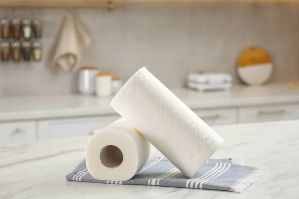 Rolls of paper towels on white marble table in kitchen