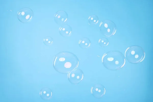 Many Beautiful Soap Bubbles Light Blue Background — Stockfoto