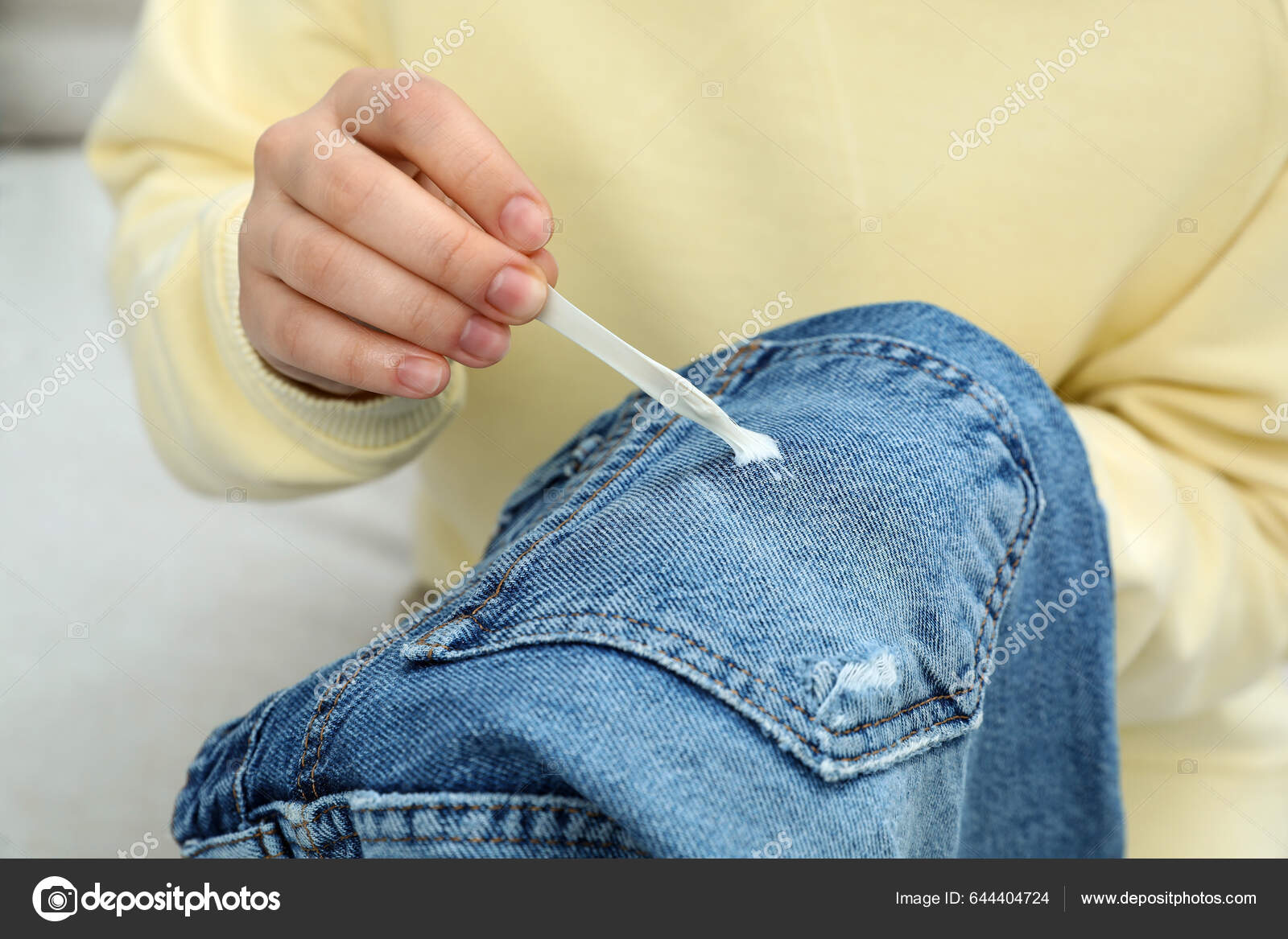Woman Removing Chewing Gum Jeans Closeup — Stock Photo © NewAfrica