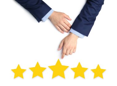 Quality evaluation. Businessman pointing at virtual golden stars on white background, closeup