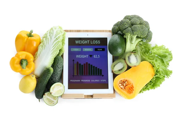 Tablet with weight loss calculator application and food products on white background, top view