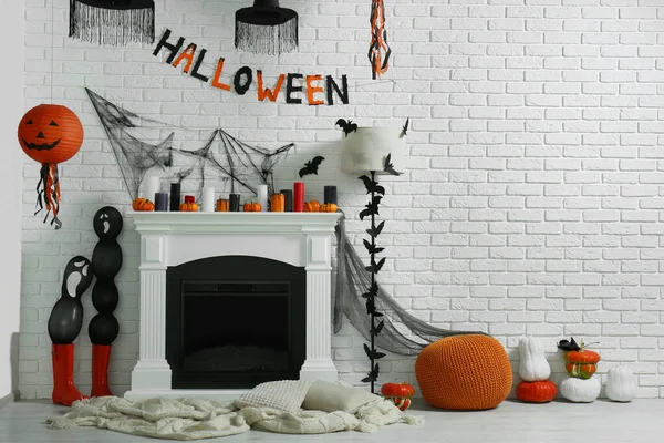 Room with fireplace and different decor for Halloween, space for text. Festive interior