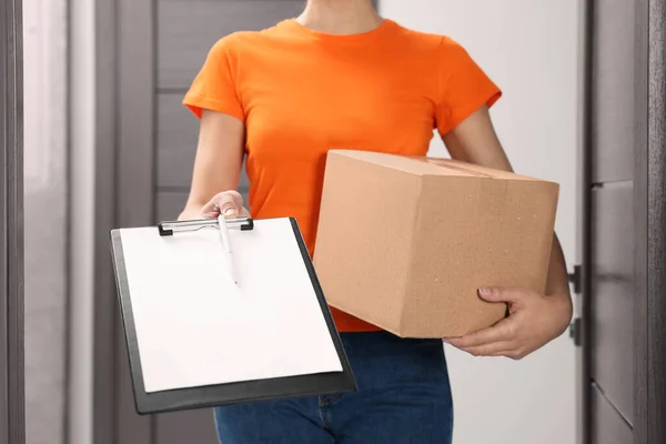 Courier Holding Parcel Clipboard Indoors Closeup — Stock Photo, Image