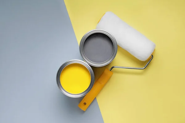 stock image Cans with different paints and roller on color background, flat lay