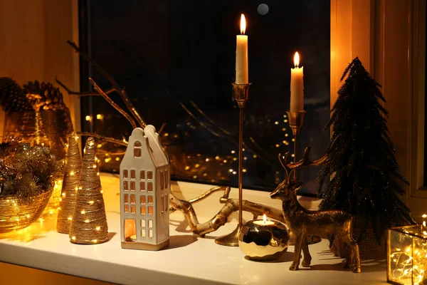 Many Beautiful Christmas Decorations Candlesticks Festive Lights Window Sill Indoors — Fotografia de Stock