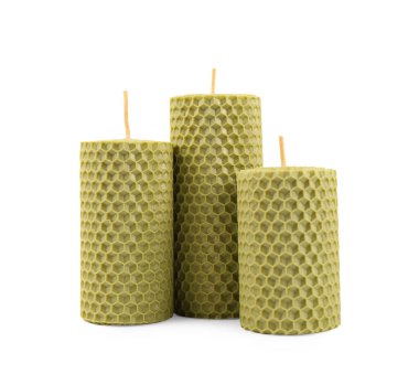 Stylish elegant beeswax candles isolated on white