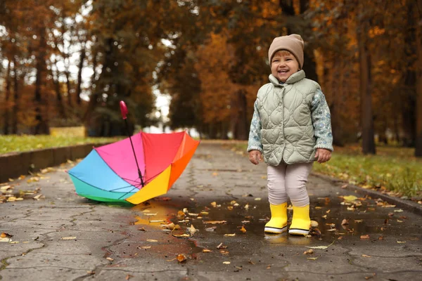 Cute Little Girl Standing Puddle Colorful Umbrella Outdoors — стоковое фото