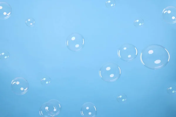 Many Beautiful Soap Bubbles Light Blue Background — Stock Photo, Image