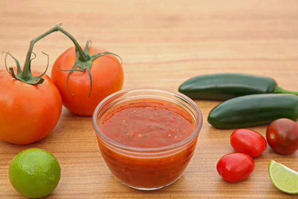 stock image Tasty salsa sauce and different ingredients on wooden table