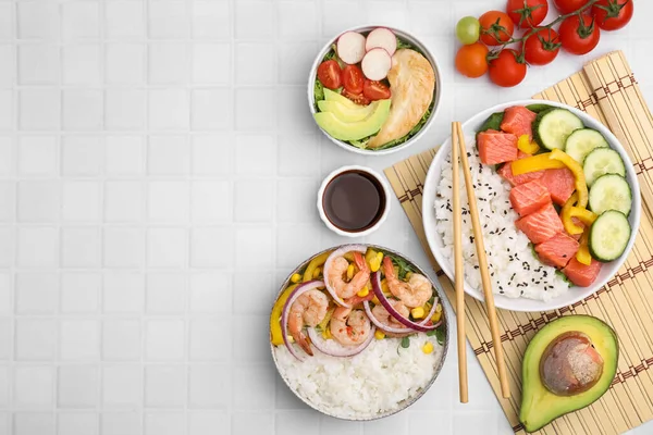 stock image Set of delicious poke bowls with different ingredients on white table, flat lay. Space for text