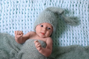 Cute newborn baby on light blue blanket, top view