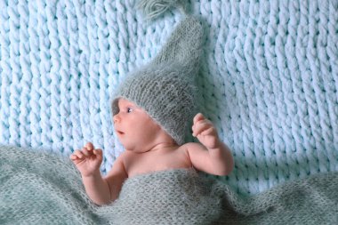 Cute newborn baby on light blue blanket, top view