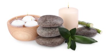 Spa stones, candles and bamboo on white background