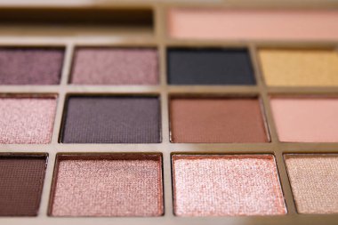 Beautiful eyeshadow palette as background, closeup. Professional cosmetic product