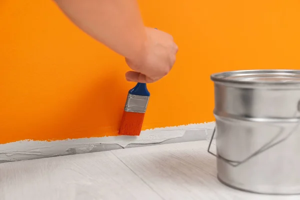 Worker Using Brush Paint Wall Orange Dye Indoors Closeup — Foto de Stock
