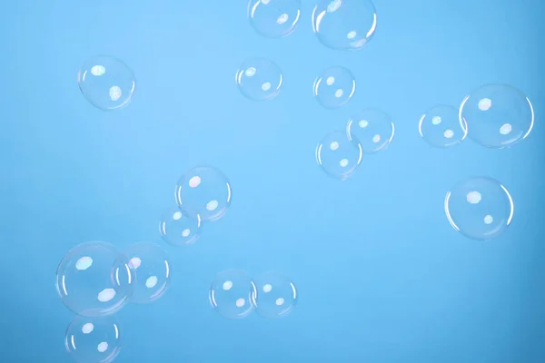 Many Beautiful Soap Bubbles Light Blue Background — Stockfoto