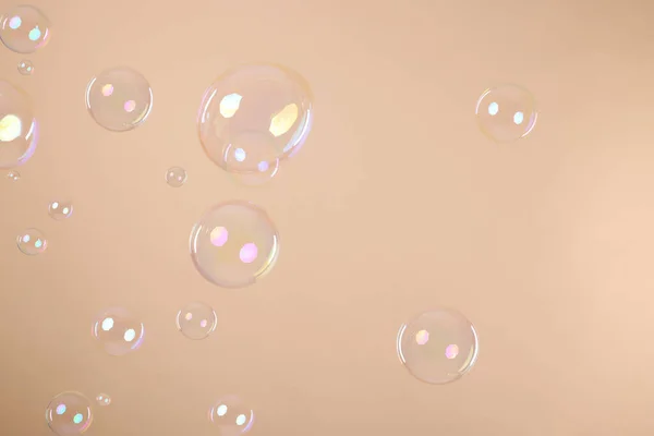 Many Beautiful Soap Bubbles Beige Background — Fotografia de Stock