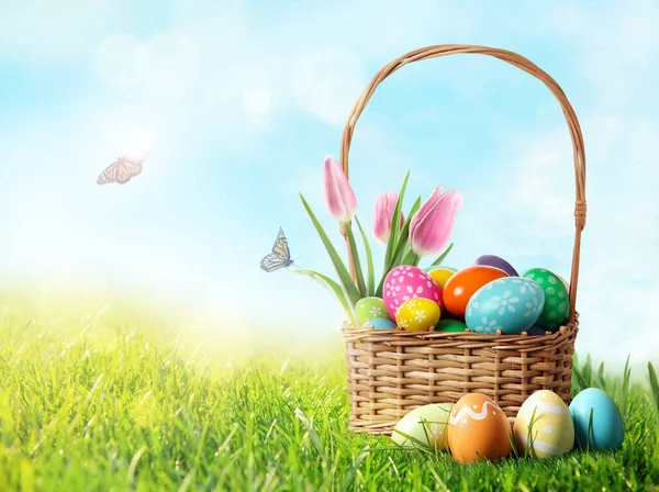 Cesta Mimbre Con Huevos Pascua Festivamente Decorados Tulipanes Hierba Verde —  Fotos de Stock