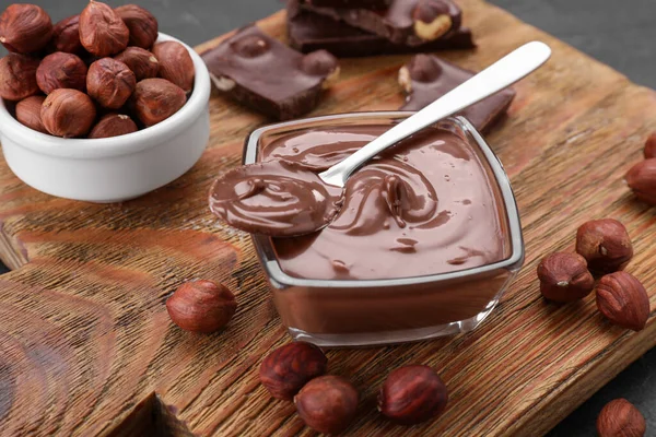用美味的糊 巧克力片和坚果在木板上的碗 特写镜头 — 图库照片