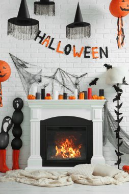 Room with fireplace decorated for Halloween. Festive interior