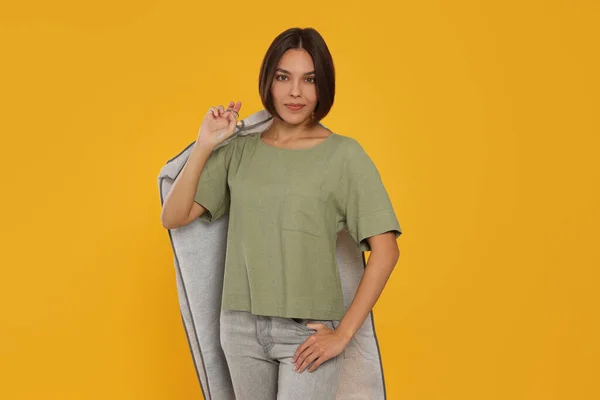 Woman Holding Garment Cover Clothes Yellow Background Dry Cleaning Service — 스톡 사진