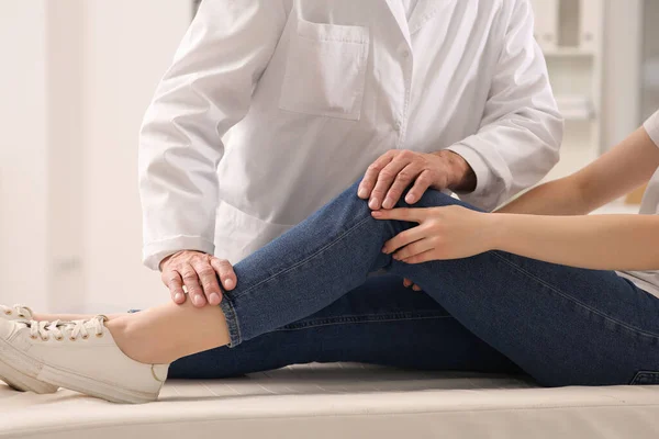 Stock image Orthopedist examining patient with injured knee in clinic, closeup