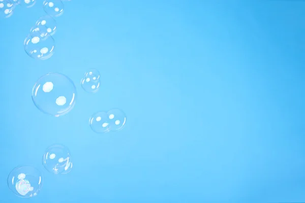 Many Beautiful Soap Bubbles Light Blue Background Space Text — Stockfoto