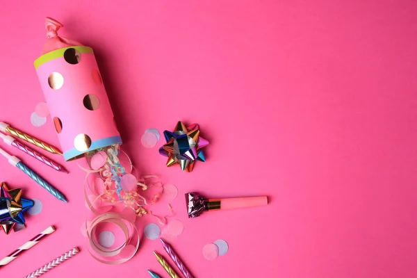 stock image Party cracker and different festive items on bright pink background, flat lay. Space for text