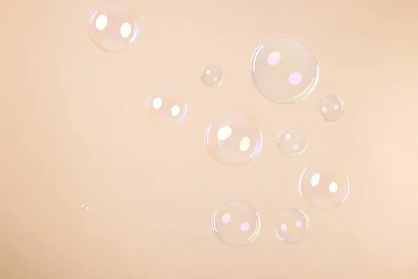 Many Beautiful Soap Bubbles Beige Background — Stock Fotó
