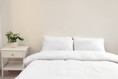 White soft pillows on cozy bed in room