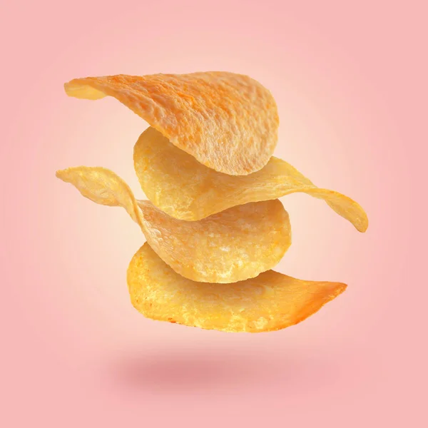 Stack Tasty Potato Chips Falling Pink Background — Stock Photo, Image