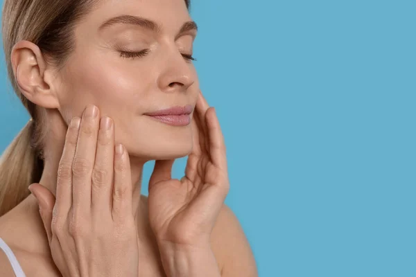 Woman Massaging Her Face Turquoise Background Space Text — 스톡 사진