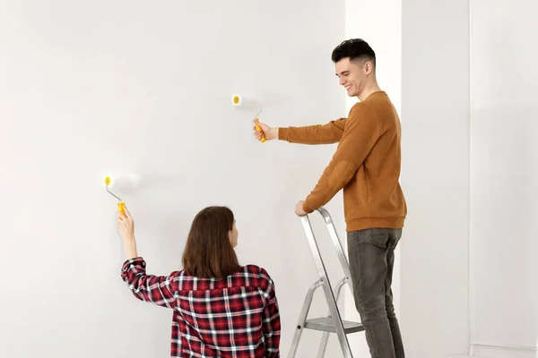 Junges Paar Bemalt Wand Mit Rollen Drinnen Raumsanierung — Stockfoto