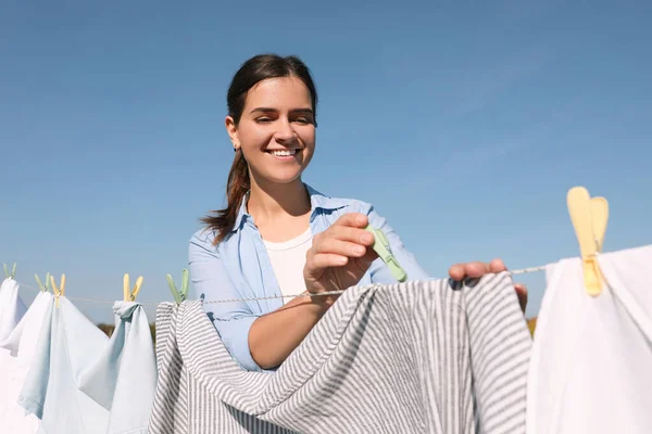 Smiling Woman Hanging Clothes Clothespins Washing Line Drying Blue Sky — Stok fotoğraf