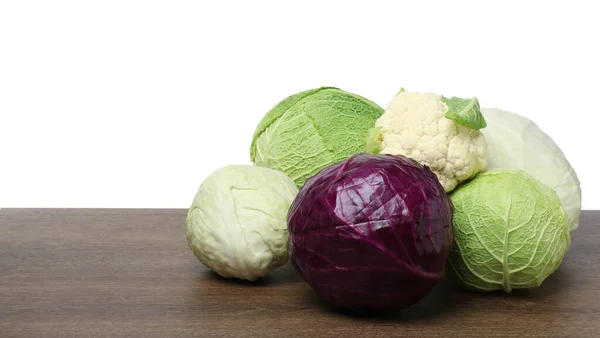 stock image Many different fresh ripe cabbages on wooden table. Space for text